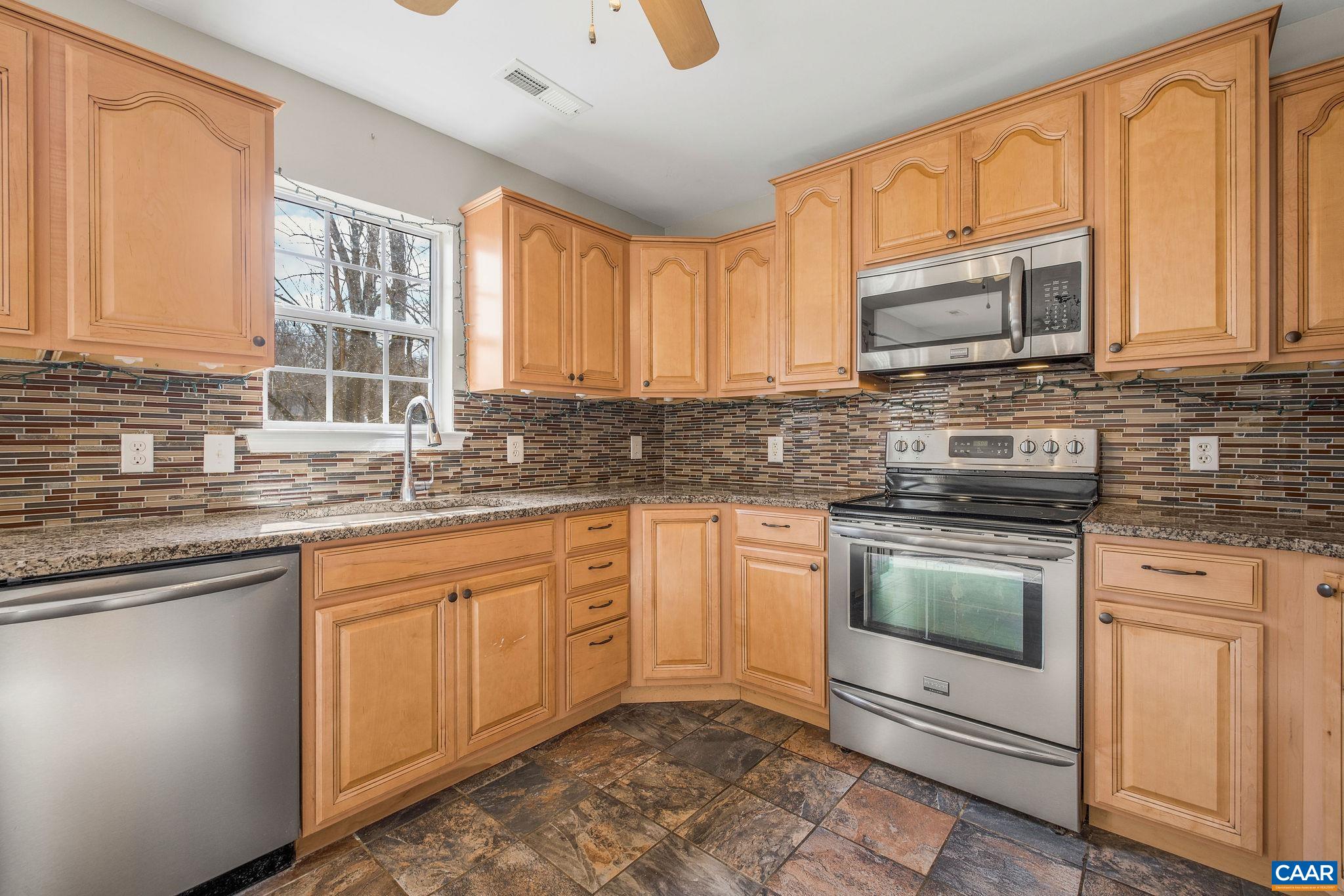 462 Fox Hunters Lane Madison, VA 22727 - Photo 25 of 65 a kitchen with stainless steel appliances granite countertop a stove sink microwave and cabinets