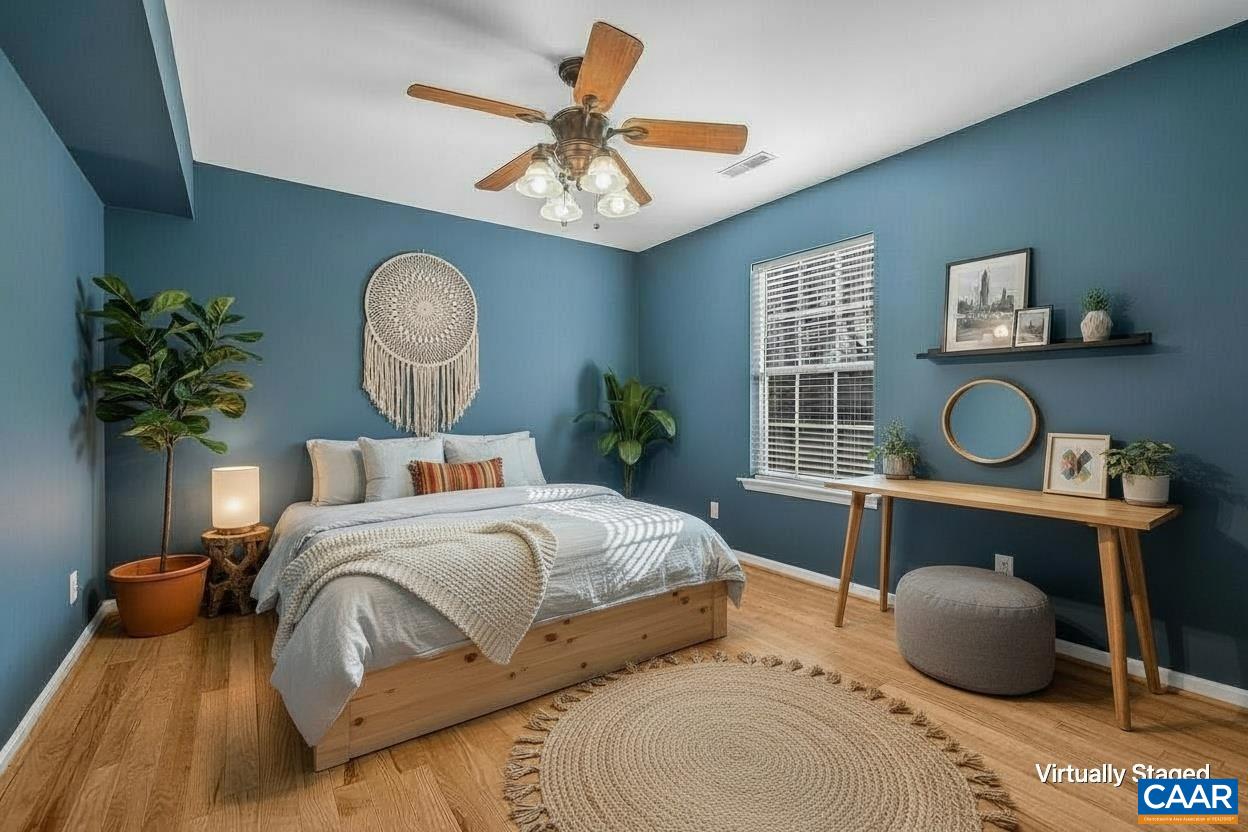 462 Fox Hunters Lane Madison, VA 22727 - Photo 32 of 65 a bedroom with a bed and a chandelier