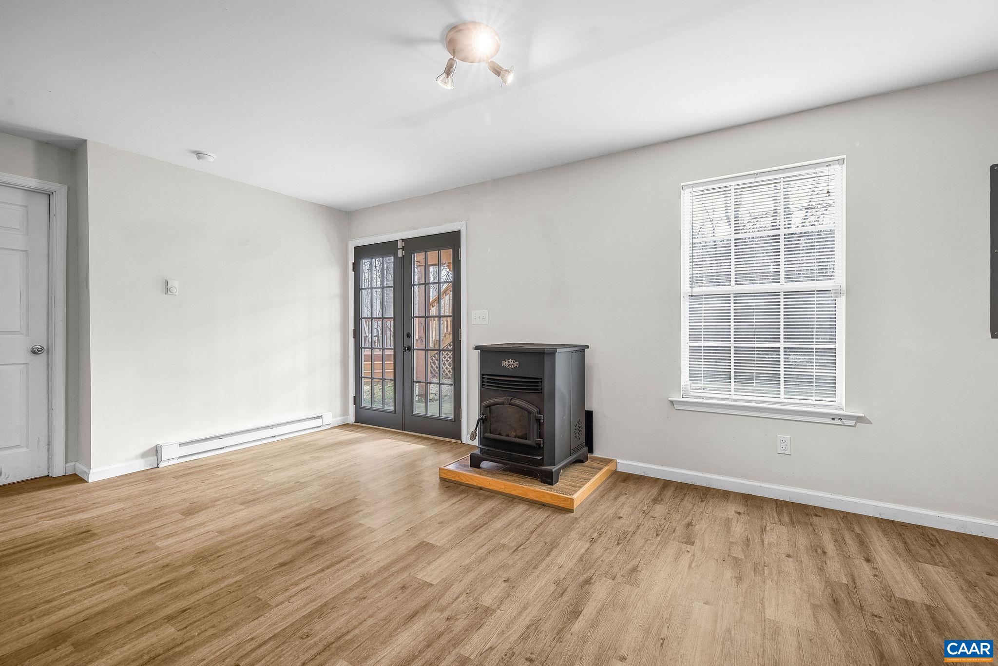 462 Fox Hunters Lane Madison, VA 22727 - Photo 43 of 65 a view of an empty room with wooden floor and a window