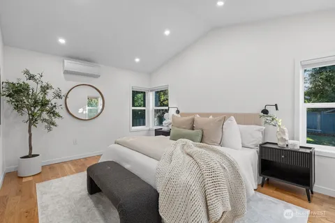 a living room with furniture a clock and a window