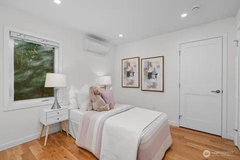 a bedroom with a large bed and a window