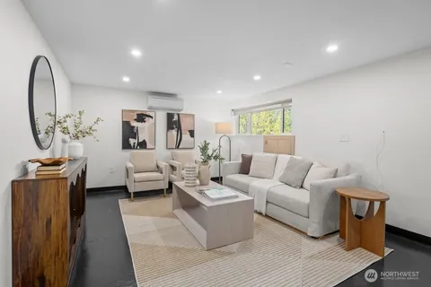 a living room with furniture a rug and a chandelier