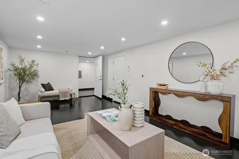 a living room with furniture and a mirror