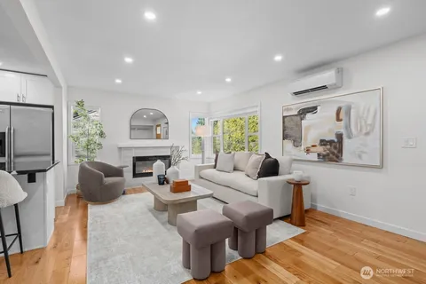 a living room with furniture a fireplace and a large window