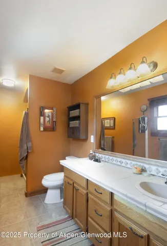a living room with furniture a window and a flat screen tv