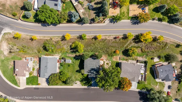 an aerial view of a house with a yard and a garage