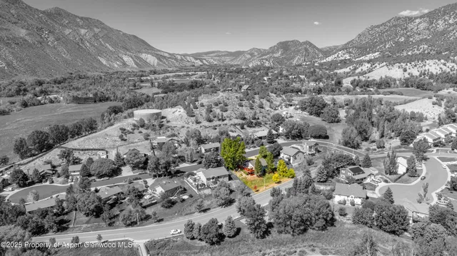 a view of a lush green hillside and houses