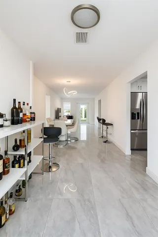 a living room with furniture and a gym machine