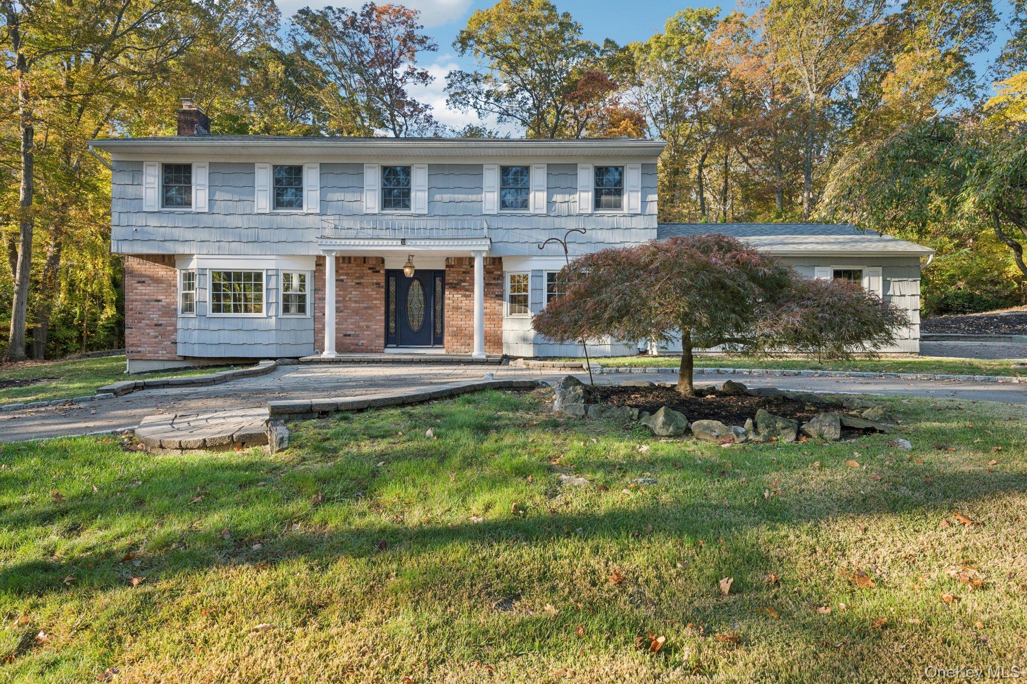 a view of a house with a yard balcony and sitting area
