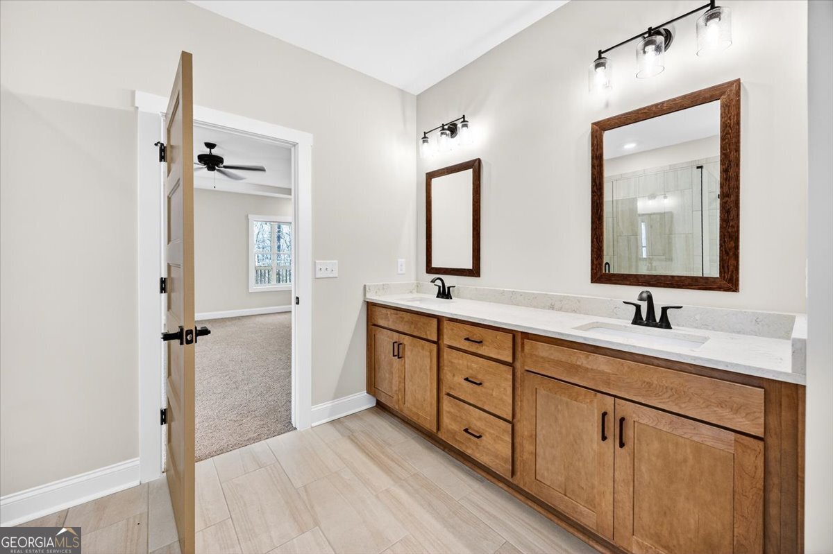 360 Indian Trail Concord, GA 30206 - Photo 25 of 67 a bathroom with a double vanity sink and mirror