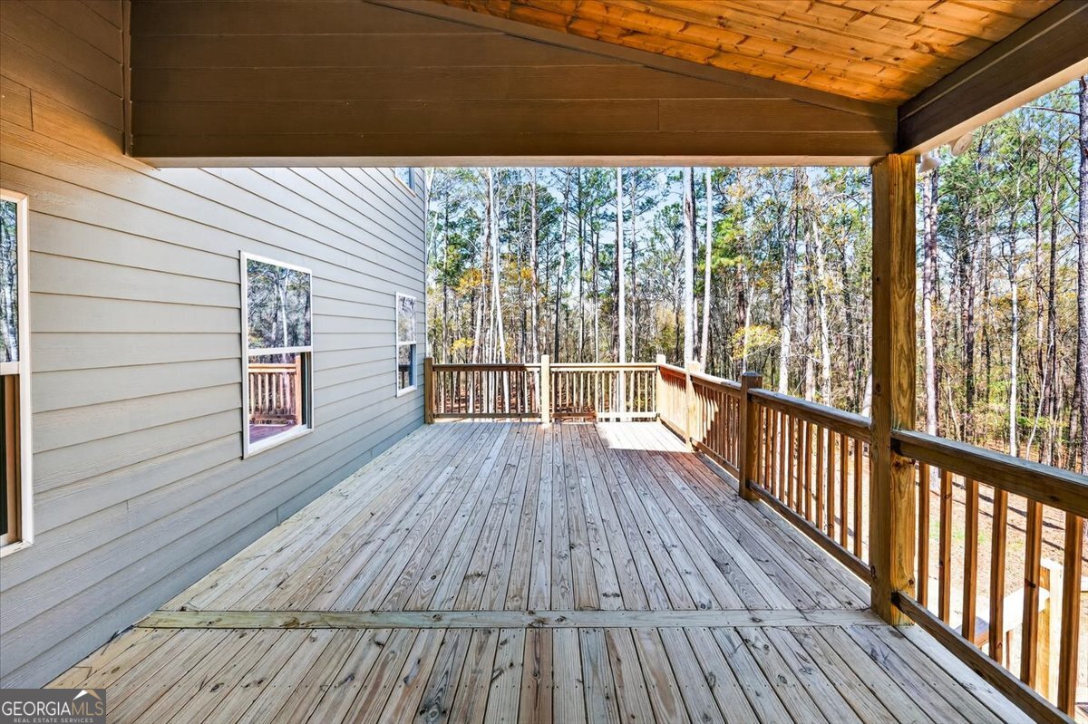 360 Indian Trail Concord, GA 30206 - Photo 27 of 67 a view of a wooden deck with a yard
