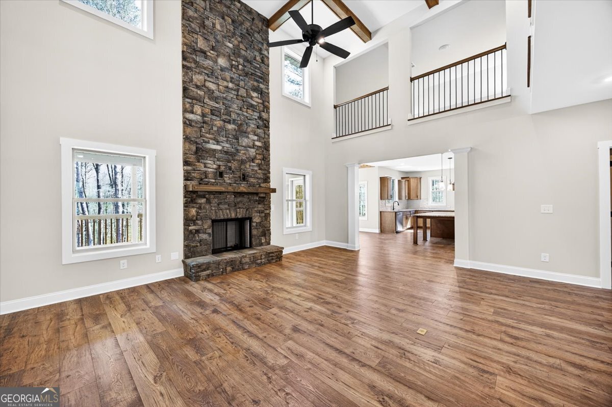 360 Indian Trail Concord, GA 30206 - Photo 4 of 67 an empty room with wooden floor and a fireplace