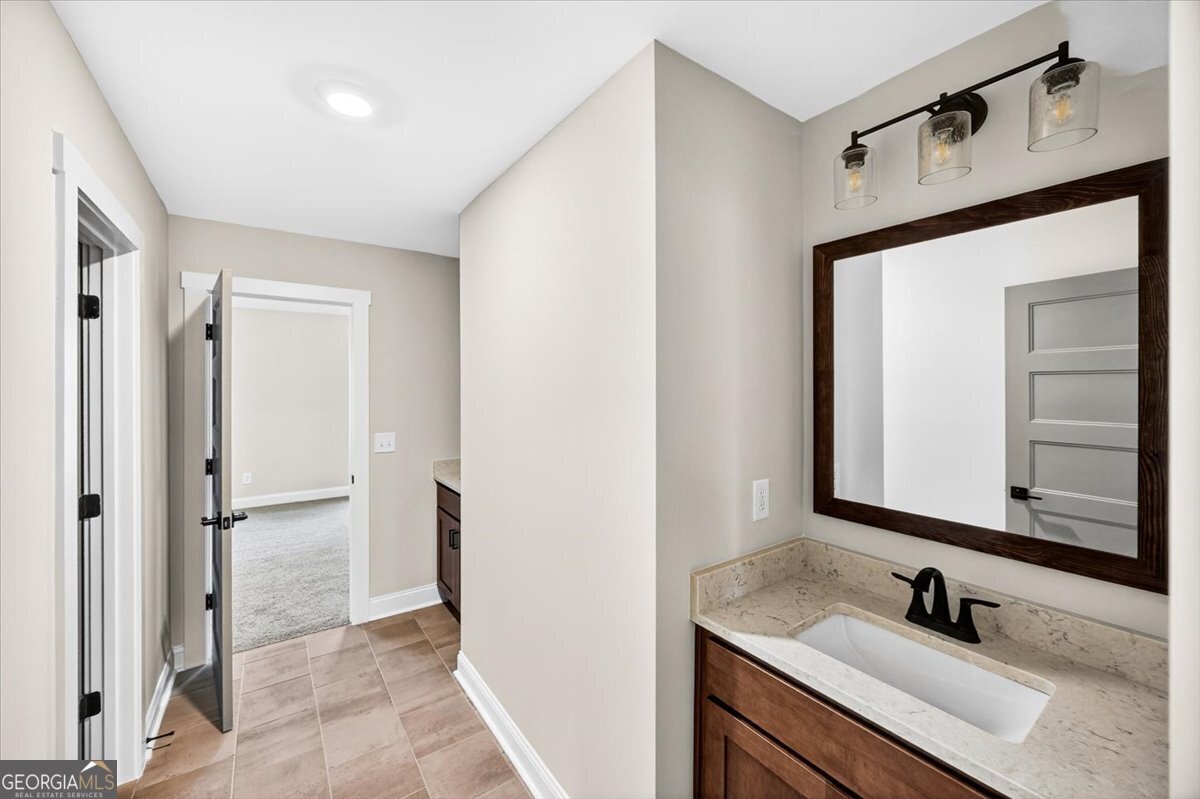 360 Indian Trail Concord, GA 30206 - Photo 45 of 67 a bathroom with a sink and a mirror