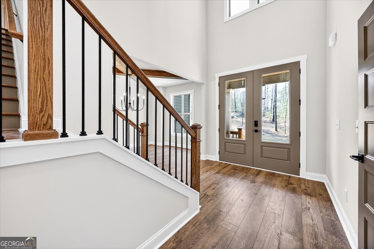 360 Indian Trail Concord, GA 30206 - Photo 6 of 67 a view of an entryway with wooden floor and stairs