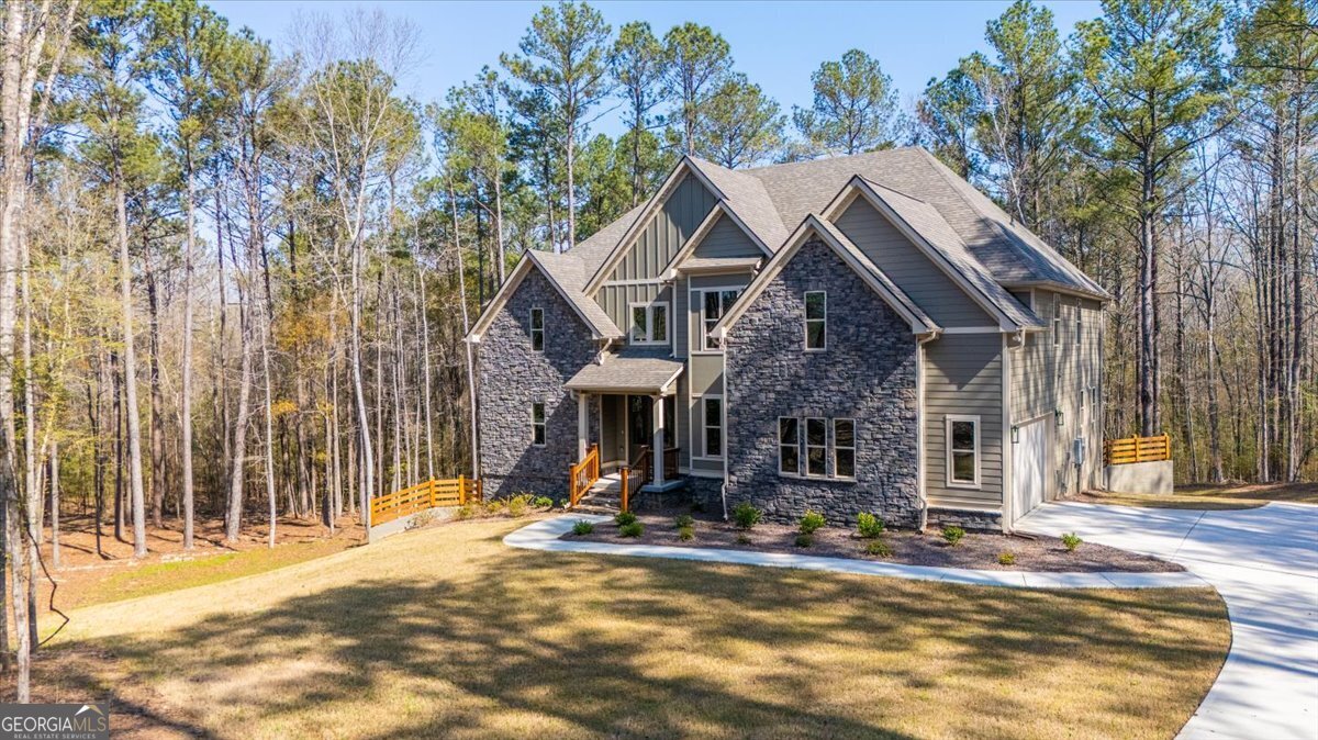 360 Indian Trail Concord, GA 30206 - Photo 63 of 67 a view of a white house with large windows and a small yard