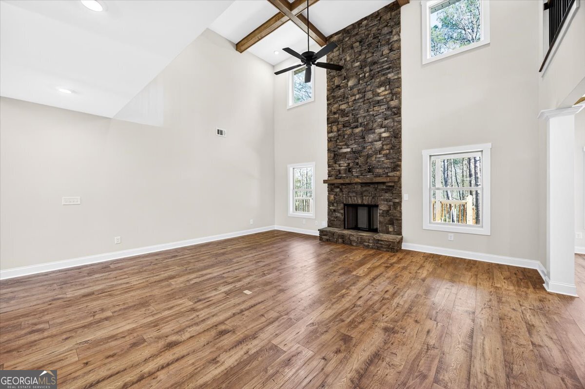360 Indian Trail Concord, GA 30206 - Photo 8 of 67 a view of a livingroom with wooden floor and a ceiling fan