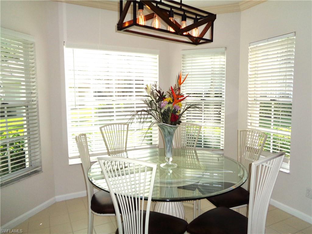 6260 Bellerive Avenue, Unit 4 Naples, FL 34119 - Photo 15 of 36 a view of a dining room with furniture window and outside view