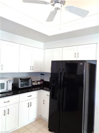 a kitchen with a refrigerator and a sink