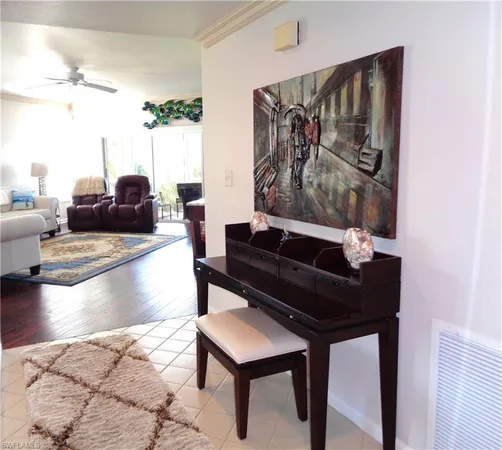 a living room with furniture and a painting on the wall