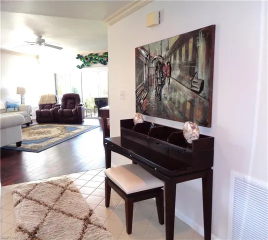a living room with furniture and a painting on the wall