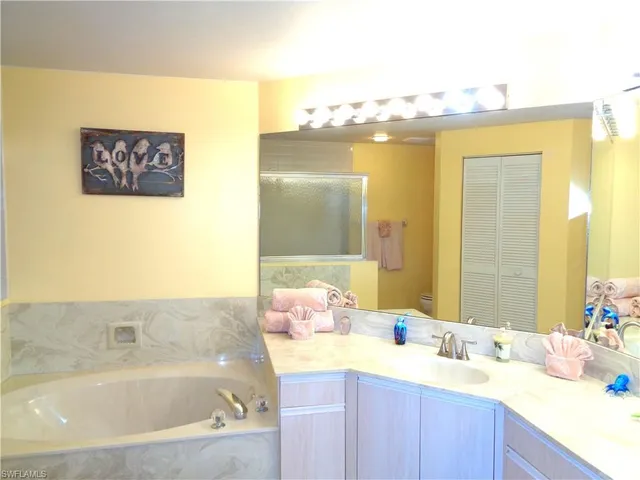 a bathroom with a bathtub sink and mirror