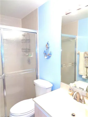 a bathroom with a toilet a sink and shower