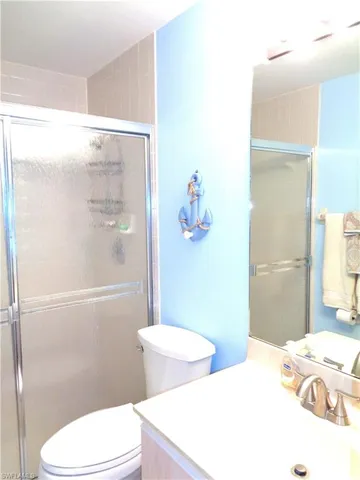 a bathroom with a toilet a sink and shower