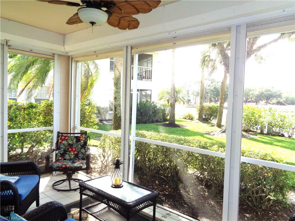 6260 Bellerive Avenue, Unit 4 Naples, FL 34119 - Photo 3 of 36 a view of a room that has a bed and a table in it