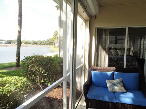 a view of a balcony with lake view and a potted plant