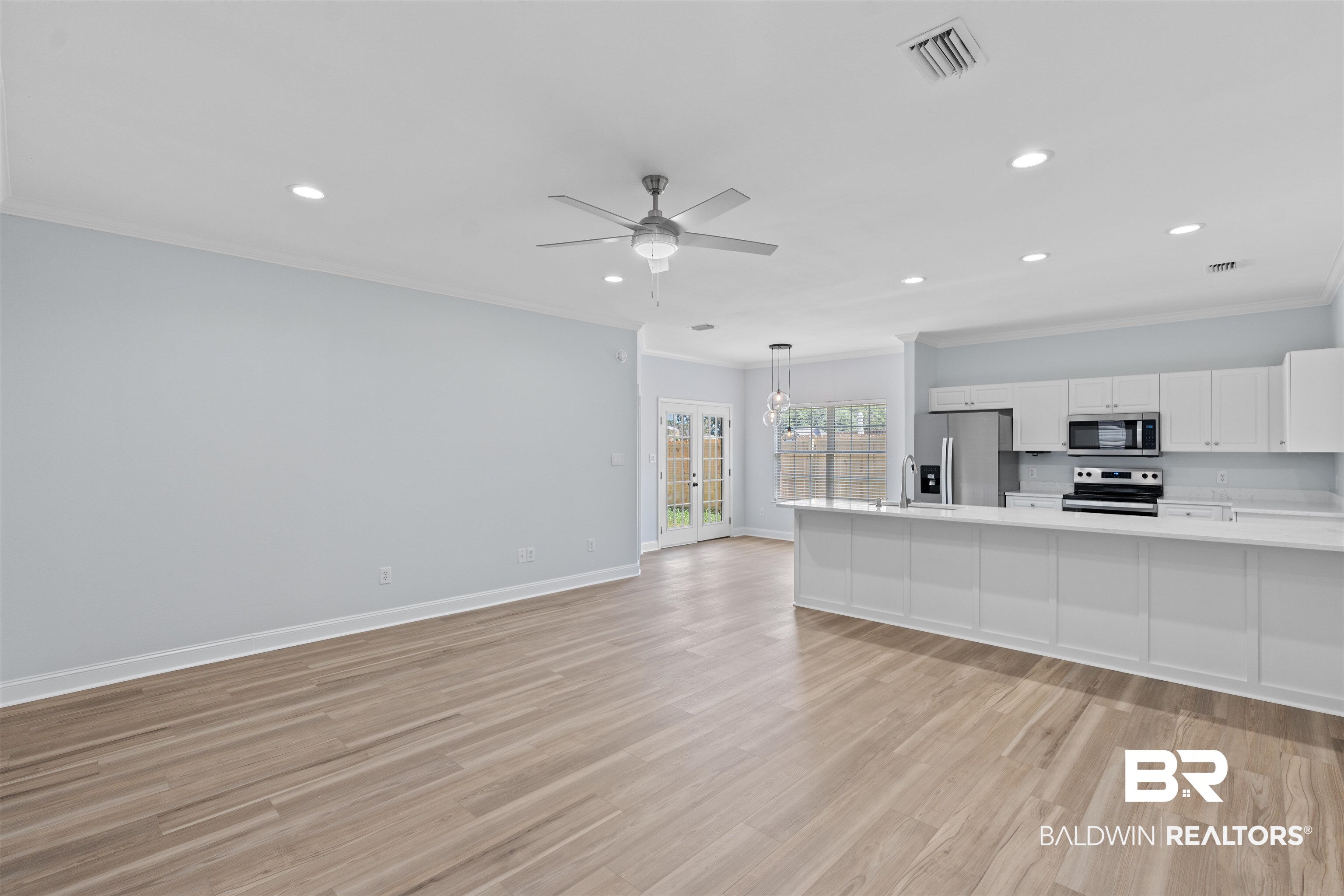 14947 Silveroaks Loop Silverhill, AL 36576 - Photo 7 of 24 Unfurnished living room featuring crown molding, light wood-style floors, recessed lighting, and ceiling fan