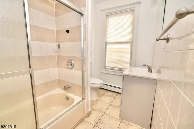 a bathroom with a tub sink and a shower