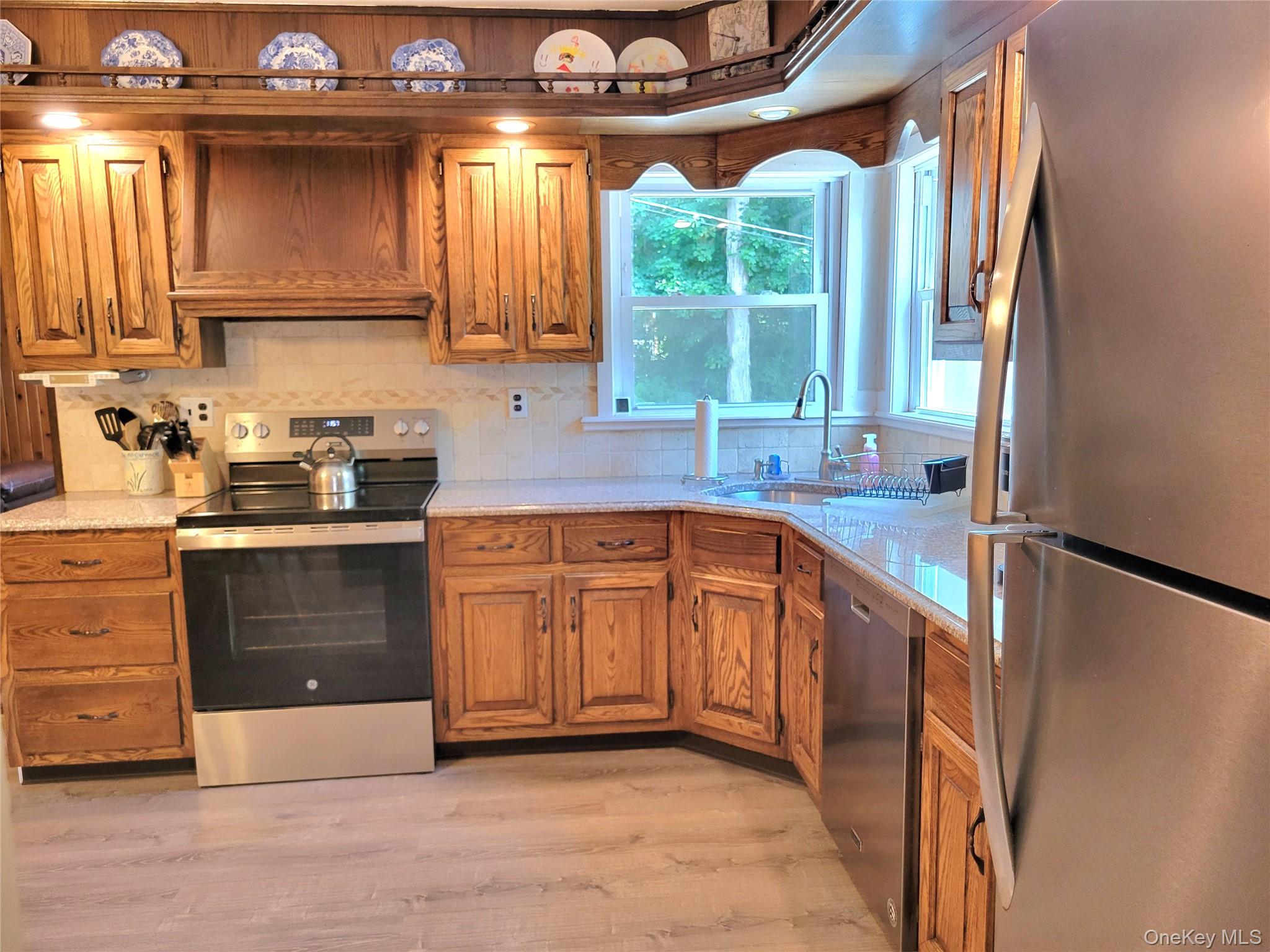 46 Cortlandt Road Mahopac, NY 10541 - Photo 6 of 36 Eat in Kitchen featuring wood cabinetry, light-toned countertops, and stainless steel . appliances. L shaped counter tops
