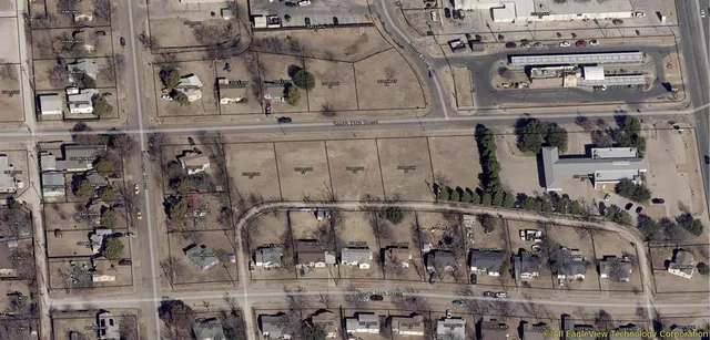 large white building with glass top table and chairs
