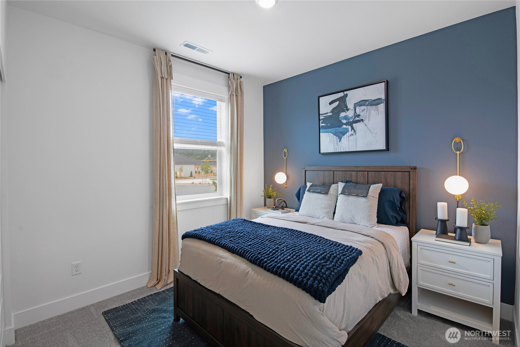 610 Gooseberry Place Sequim, WA 98382 - Photo 19 of 31 a bedroom with a bed and lamp