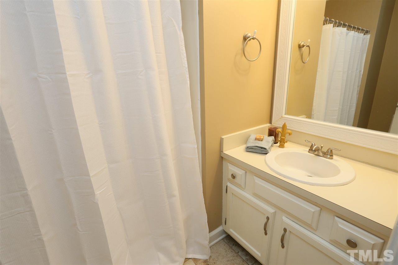 814 Temple Street Raleigh, NC 27609 - Photo 15 of 19 Hall bathroom is easily accessible to bedroom 2 and 3 as well as for guests. Tub/ shower combo and good counter space.