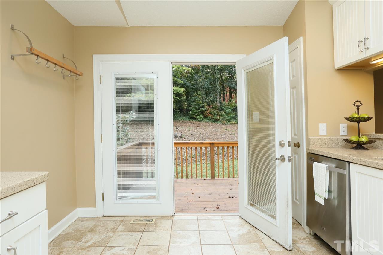 814 Temple Street Raleigh, NC 27609 - Photo 9 of 19 Access to the deck from the kitchen and the dining area. Open up the doors in spring and fall and live easily between the inside and outside.