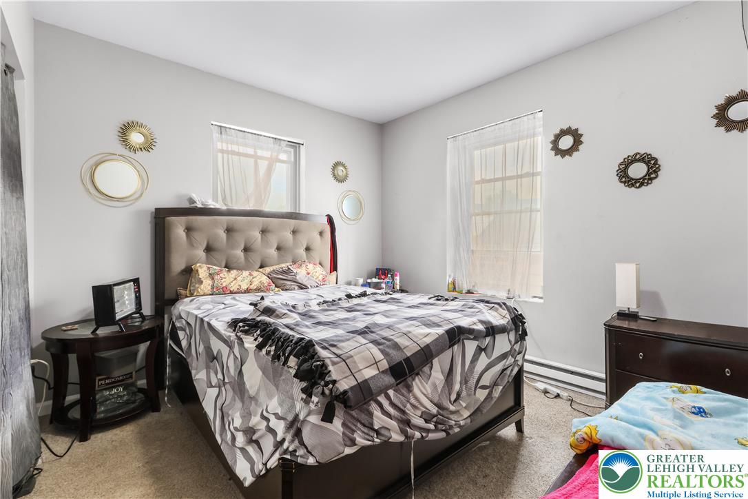 12 South Front Street Coplay, PA 18037 - Photo 15 of 41 This cozy bedroom features bright windows and ample space, ideal for peaceful rest and relaxation.