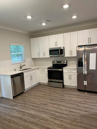 a kitchen with a white cabinets and white appliances