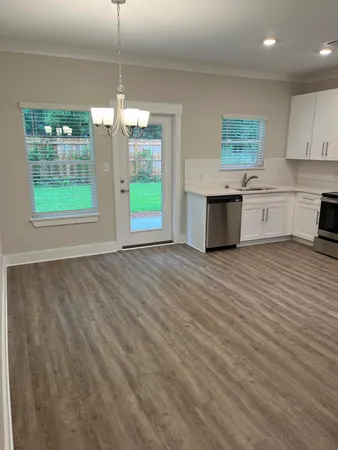 a view of kitchen and hall with wooden floor