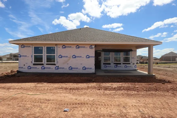 a kitchen with kitchen island white cabinets and stainless steel appliances