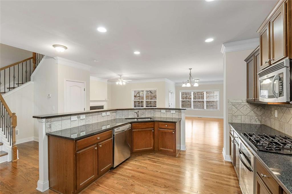 3199 Buck Way Alpharetta, GA 30004 - Photo 11 of 43 a kitchen with stainless steel appliances granite countertop a stove a sink and a refrigerator
