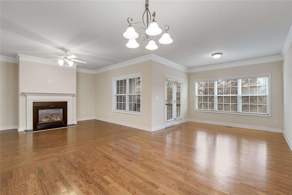 3199 Buck Way Alpharetta, GA 30004 - Photo 17 of 45 a view of an empty room with wooden floor and a fireplace