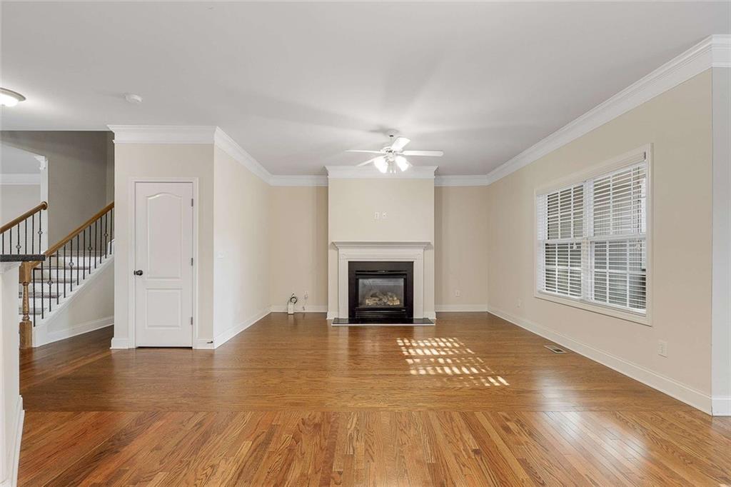 3199 Buck Way Alpharetta, GA 30004 - Photo 19 of 45 a view of an empty room with wooden floor fireplace and a window