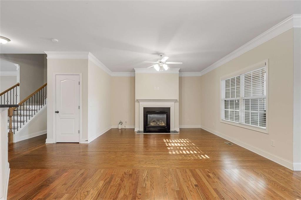 3199 Buck Way Alpharetta, GA 30004 - Photo 19 of 43 a view of an empty room with wooden floor fireplace and a window