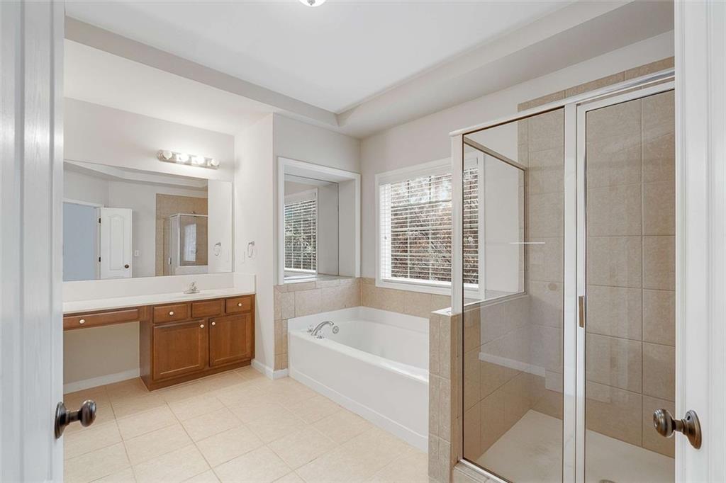 3199 Buck Way Alpharetta, GA 30004 - Photo 23 of 43 a bathroom with a tub sink shower and mirror