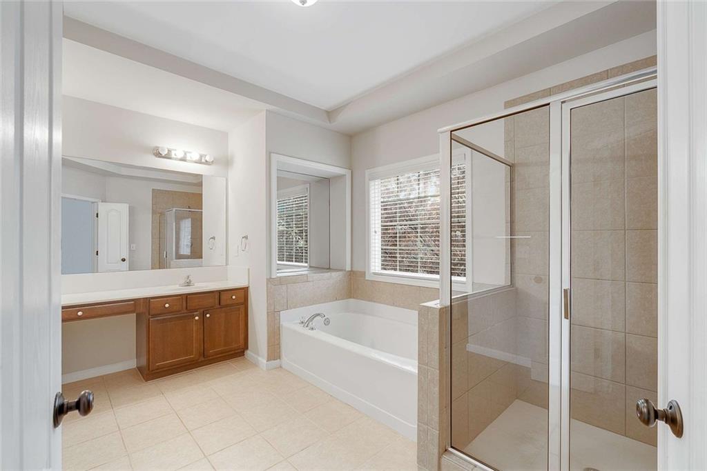 3199 Buck Way Alpharetta, GA 30004 - Photo 23 of 45 a bathroom with a tub sink shower and mirror