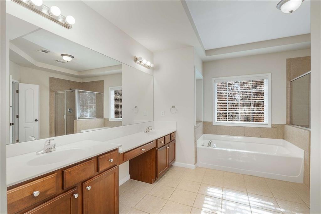 3199 Buck Way Alpharetta, GA 30004 - Photo 24 of 45 a spacious bathroom with a tub sink and mirror