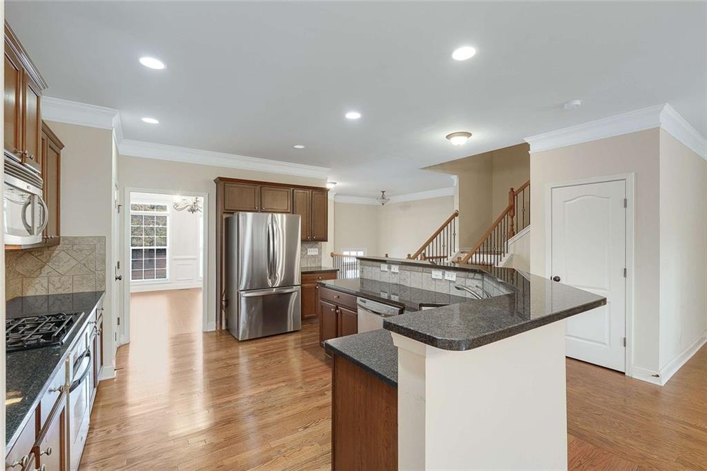 3199 Buck Way Alpharetta, GA 30004 - Photo 8 of 45 a kitchen with stainless steel appliances granite countertop a sink stove and refrigerator
