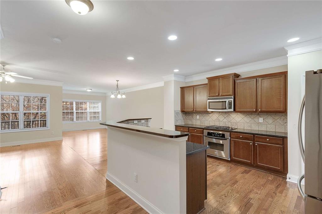 3199 Buck Way Alpharetta, GA 30004 - Photo 9 of 45 a kitchen with stainless steel appliances granite countertop a stove and a sink
