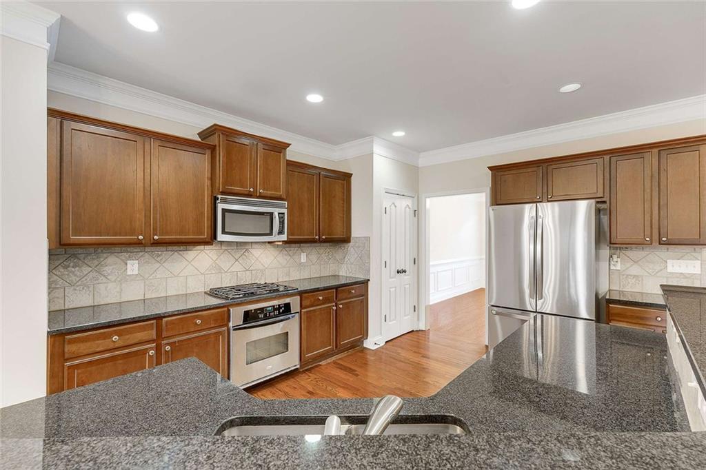 3199 Buck Way Alpharetta, GA 30004 - Photo 10 of 45 a kitchen with stainless steel appliances granite countertop a refrigerator a stove and a sink